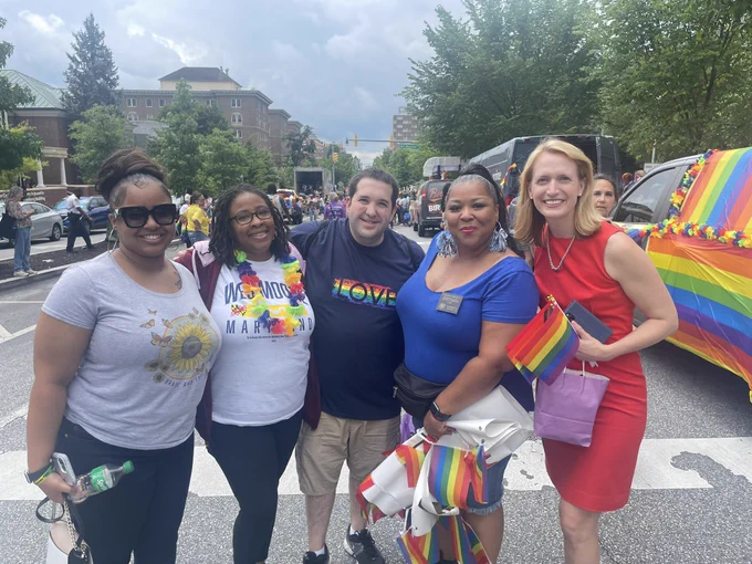 Brooke and community members with rainbow flags