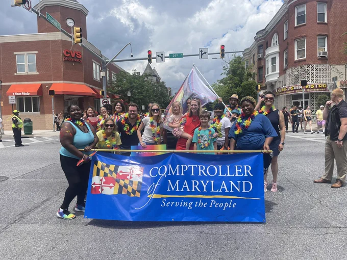 Comptroller of Maryland banner with Brooke and others behind it