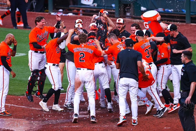 Everyone celebrates at home plate after Ryan McKenna hit a walk-off home run.