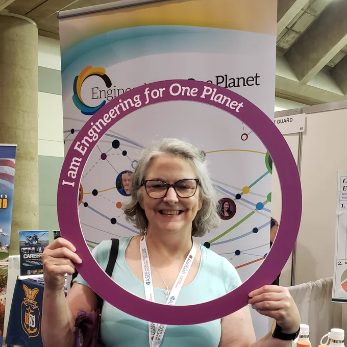 Woman with a ring that says Engineering for One Planet