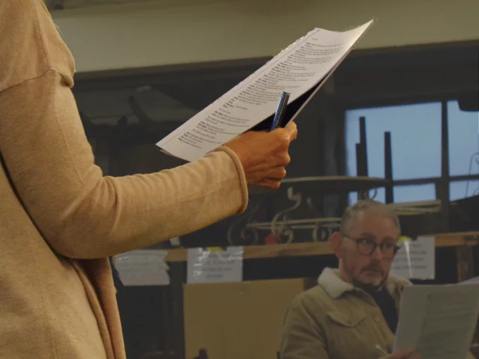 Actors with scripts in a workshop setting