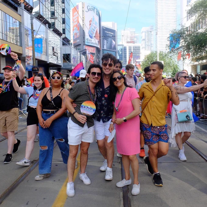 Minister Anand pictured with marchers in Toronto Pride Parade.