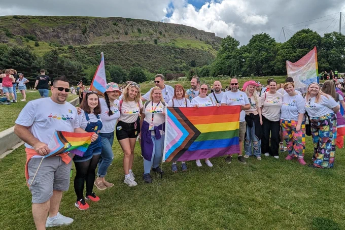 Edinburgh Zoo and RZSS staff posing at Holyrood park with pride t shirts and flags