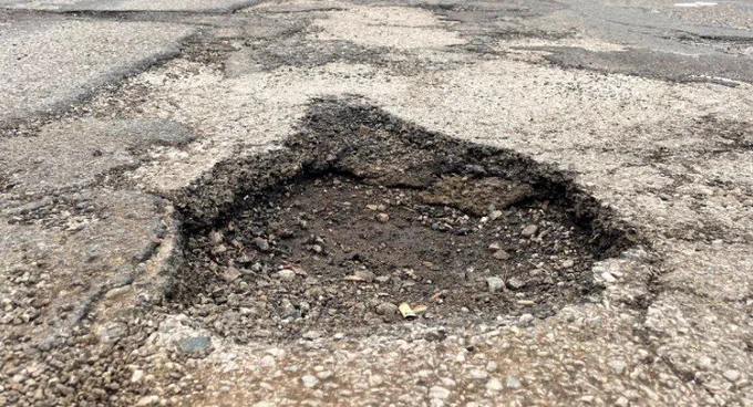 Car breaking pothole