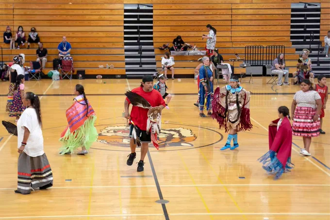 Dancers participate in the red Ribbon Skirt society dance special