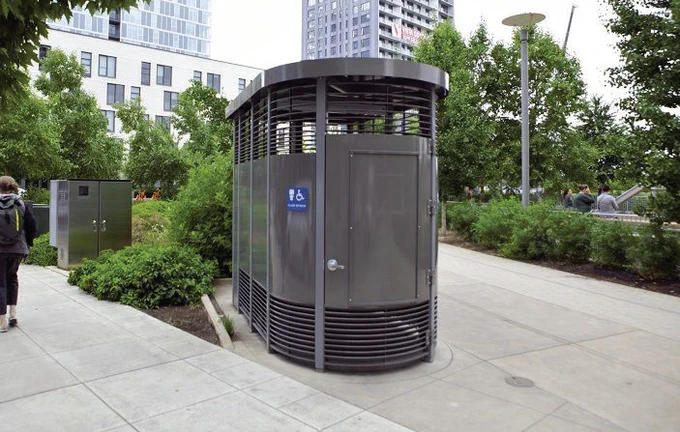 handicap accessible outdoor restroom set in an urban park