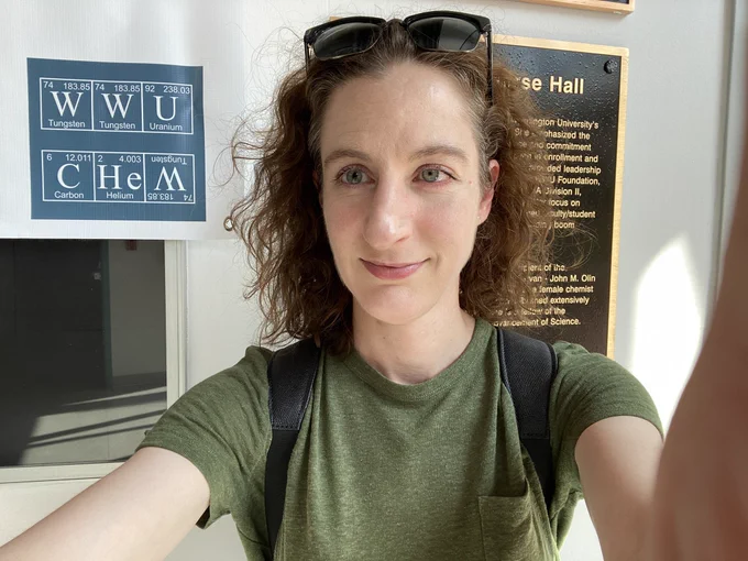 A selfie of Sierra in front of a WWU Chem sign. The letters are written like elements on the periodic table.