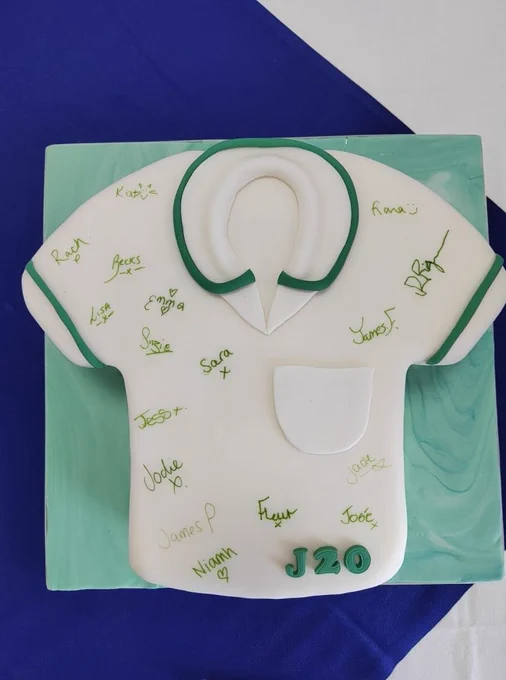 Cake designed as an occupational therapist's tunic, signed by students