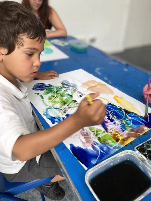 One of the younger pupils creating his watercolour artwork.