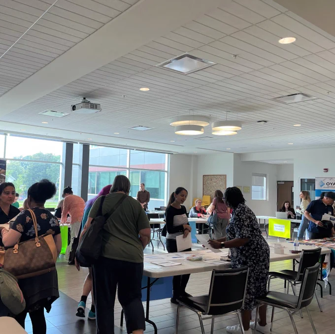 Image of facilitators talking to new HWDSB employees at orientation.