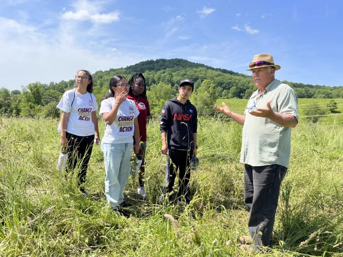 Mike Sands, a local farmer, talks to a group of high school students at Eldon Farms, VA, about the ways that agriculture and conservation can work in synergy by planting native plants for grazing cattle; photo by Jennifer Brundage, Smithsonian Affiliations.   
