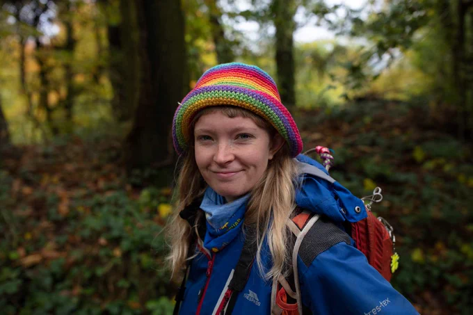 PhD student Ella Boswell standing in a forest.