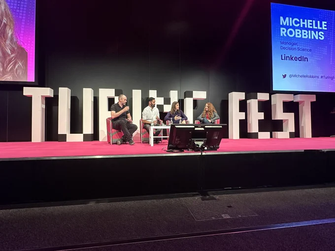 A panel of speakers discussing the impact of AI on-stage at Turing Fest in Edinburgh