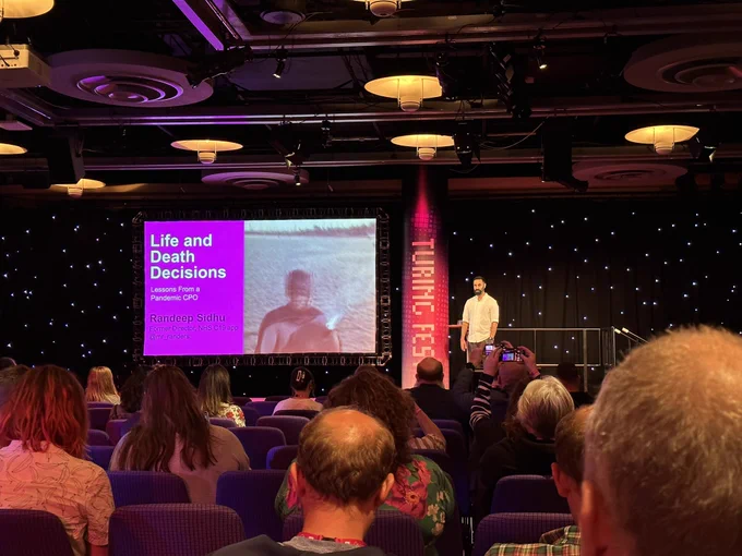 Randeep Sidhu presenting on-stage at Turing Fest in Edinburgh.