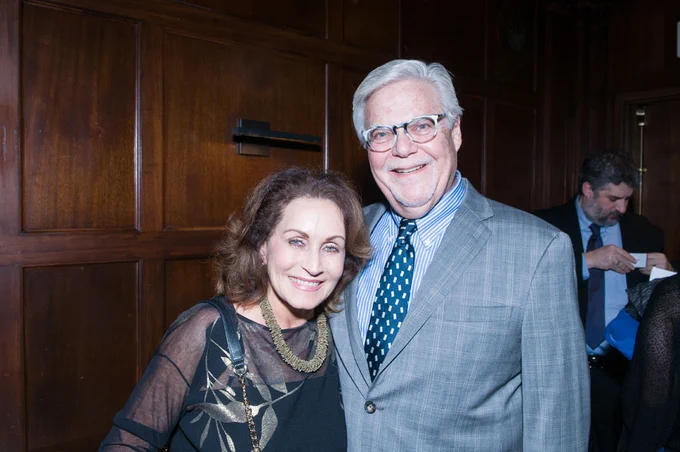 Leslye, in a black and gold dress, and Michael, in a gray plaid suit, pose together at the LightHouse gala in 2018

