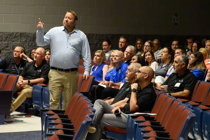 man standing in the crowd giving a presentation