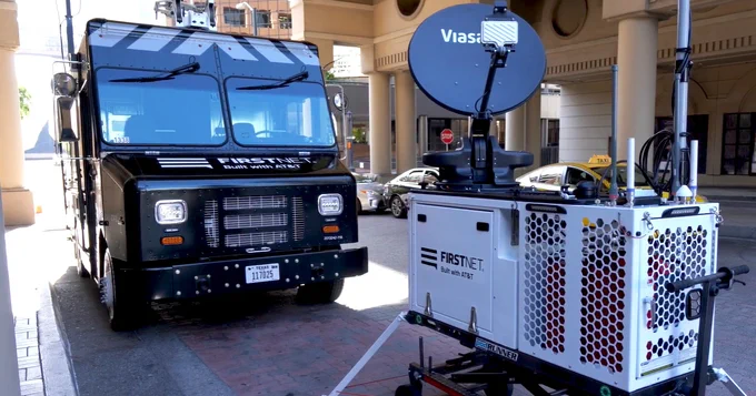 a CRD next to a FirstNet vehicle outside on the street in front of a building