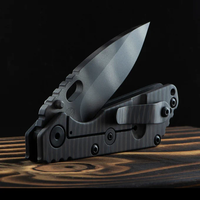 Side-on image of the Strider SNG Tigertrack Drop Point Folding Knife. The blade is partially open on this liner-lock knife