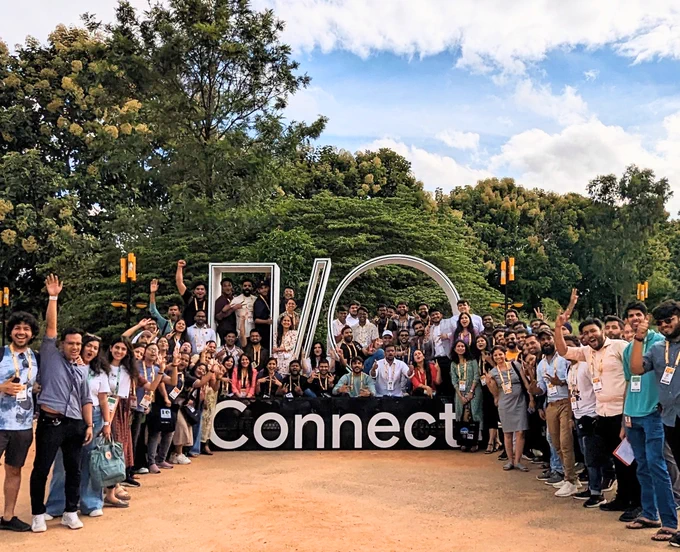 Image of developers in front of a sign that says "I/O Connect" at Google IO Connect, Bengaluru