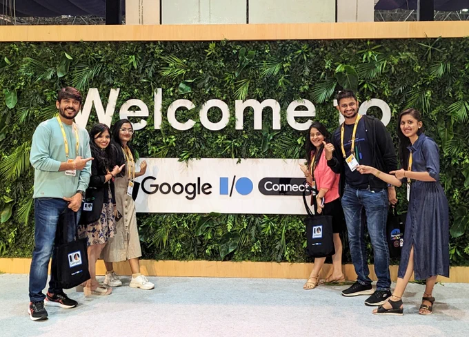 Image of developers standing in front of a sign that says "Welcome to Google I/O Connect" at Google IO Connect, Bengaluru