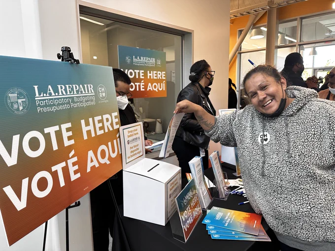 A woman casts her vote in Watts as part of L.A. REPAIR, LA's first participatory budgeting project.