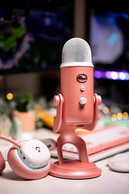 A Logitech G Aurora Collection Yeti Microphone paired with a G735 and G715. All are in the Pink Dawn colorway.