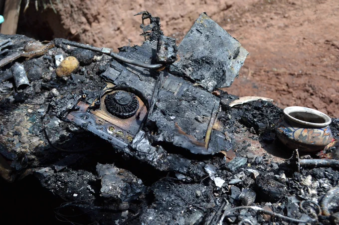 Remain of the laptop which caused the fire. A fire damaged fan and motherboard can be seen.