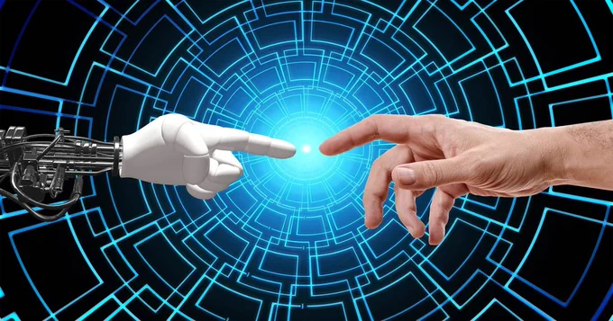 Robotic hand and human hand against a blue grid background.