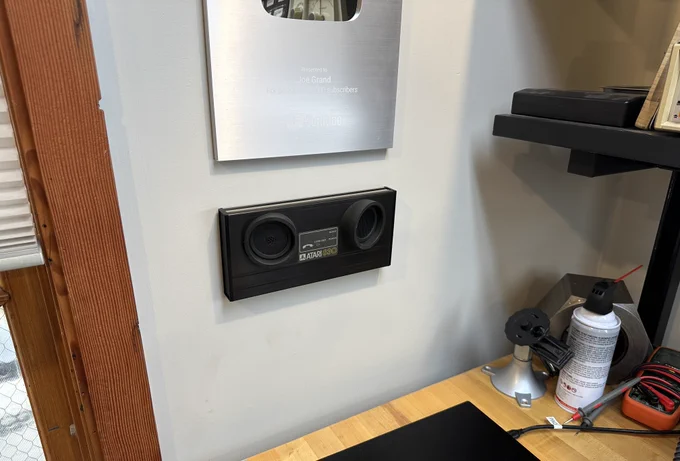 Joe Grand's first modem, the Atari 830 acoustic coupler, mounted on the wall next to his workbench to remind him of what started it all.