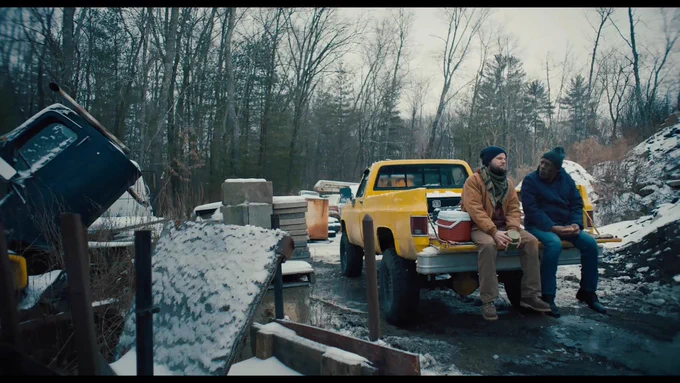 Two veterans share a quiet moment in a snowy work yard in Sheepdog, a film that explores post-traumatic growth, friendship and the long road of reintegration after military service. (Credit: Team House)