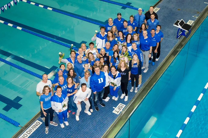Duke Swimming and Diving senior class posing with family and friends poolside during the Senior Day ceremony at Taishoff Aquatics Pavilion.