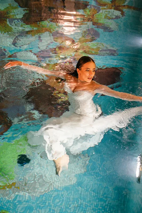 A bridal editorial set in a historic villa's iconic interior pool.