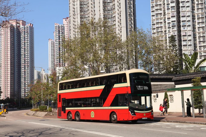 Kowloon Motor Bus V6B210 (ZZ 6552) is a Volvo B8L/MCV in the Kowloon Motor Bus retro livery featuring a cream top with a red centre band, followed by another cream band below the lower deck windows. The bottom is in the red of KMB. It is pictured in Tin Shui Wai on route 269B.