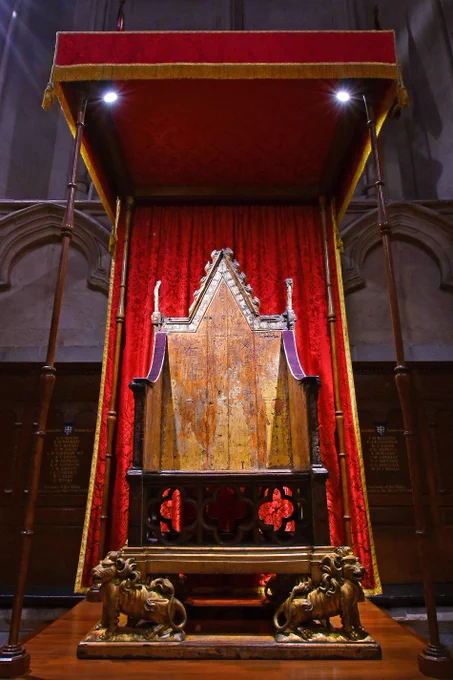 The ancient oak Coronation Chair, displayed beneath a red velvet canopy