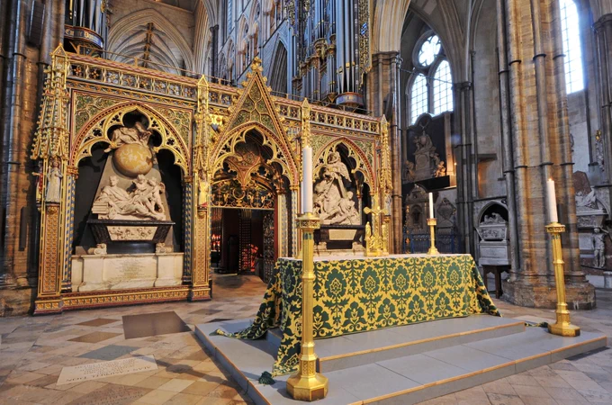 The nave altar in Westminster Abbey, dressed in a green and gold fontal, and with two large candlesticks standing beside it