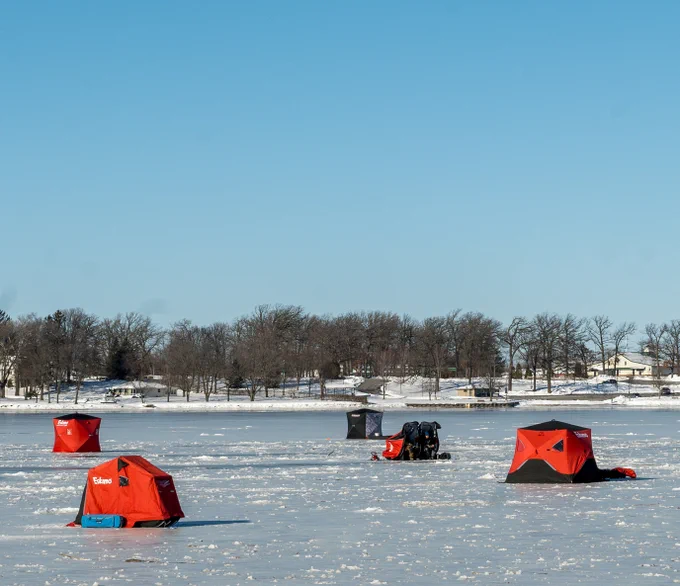 Ice shantys on a frozen lake