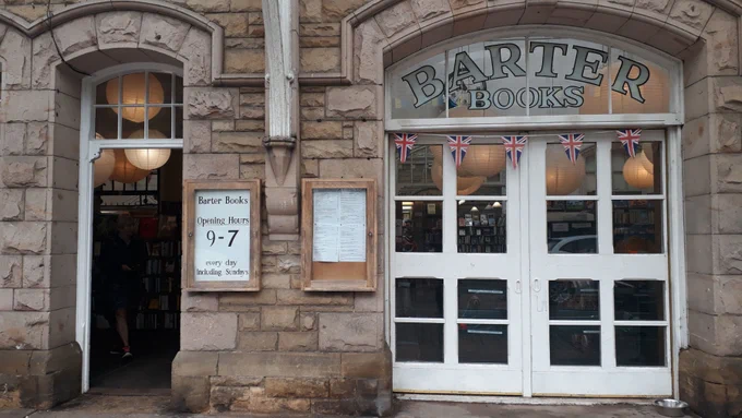 Stone exterior of Barter Books with traditional glazed doors and signage