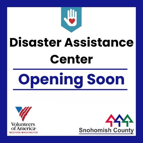 Blue border with white background. Text says "Disaster Assistance Center Coming Soon." Logos for Volunteers of American Western Washington and Snohomish County are below the text. 
