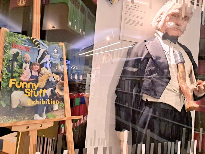 Poster on easel adjacent to comedy Victorian murder mannequin in black tie and tails 