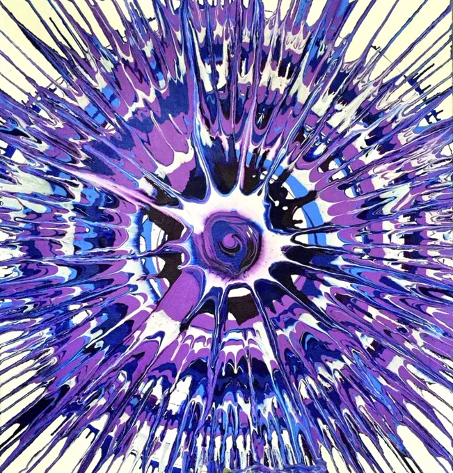 Spin art on a white background with purple, black, white, and dark and light blue paints.