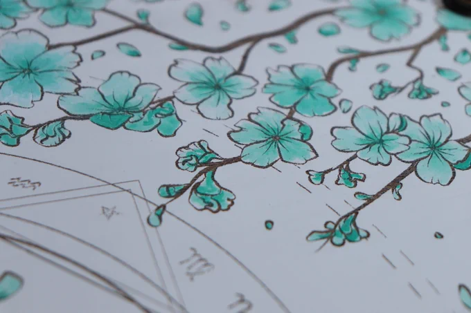 a close  up of white leather painted with teal cherry blossom