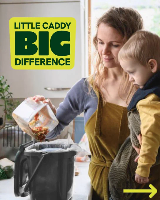 Little caddy. Big difference. A woman pours leftovers from a Tupperware container into a food waste kitchen caddy whilst holding a young child on her hip in a kitchen. 