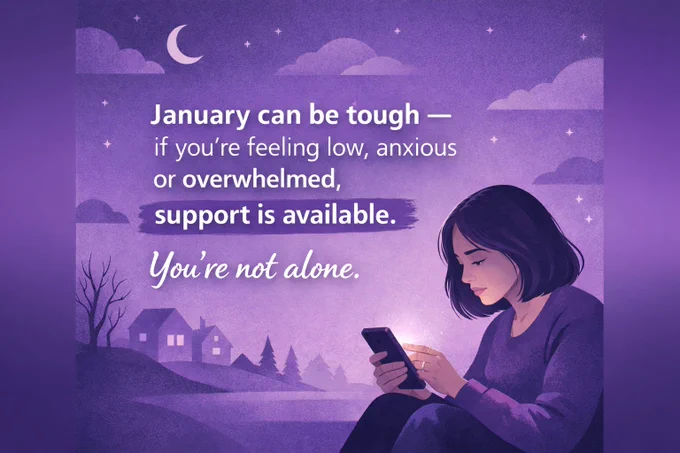 A person sitting outdoors at night looking at their phone with a message about support for anxiety and feeling overwhelmed in January.