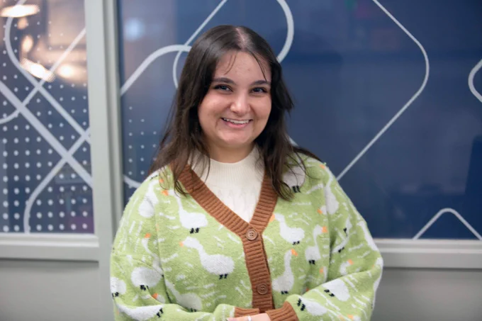 [ID: Pictured is a photo of Elli Ferren. Elli works as a Research Mav here at the UTA Central Library.]