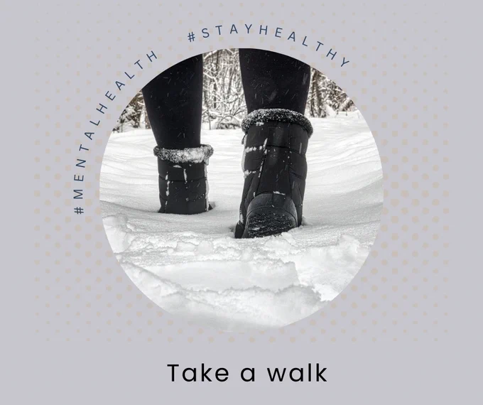 A black and white photograph of booted feet walking in the snow.