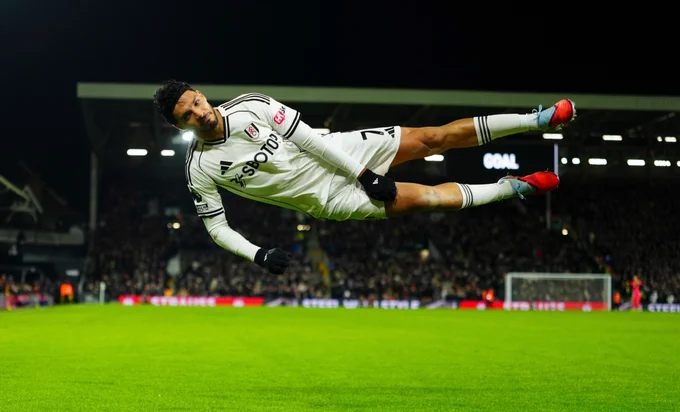 Raúl Jiménez in mid-air celebrating his goal against Chelsea.