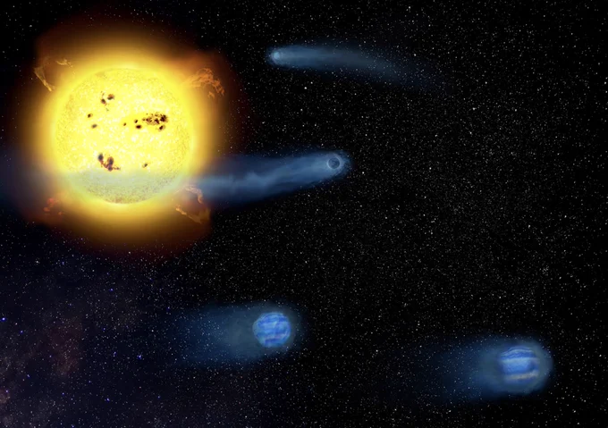 恒星V1298Tauの周りを、ふわふわな惑星4つがガスの尾を引くように回っている様子。