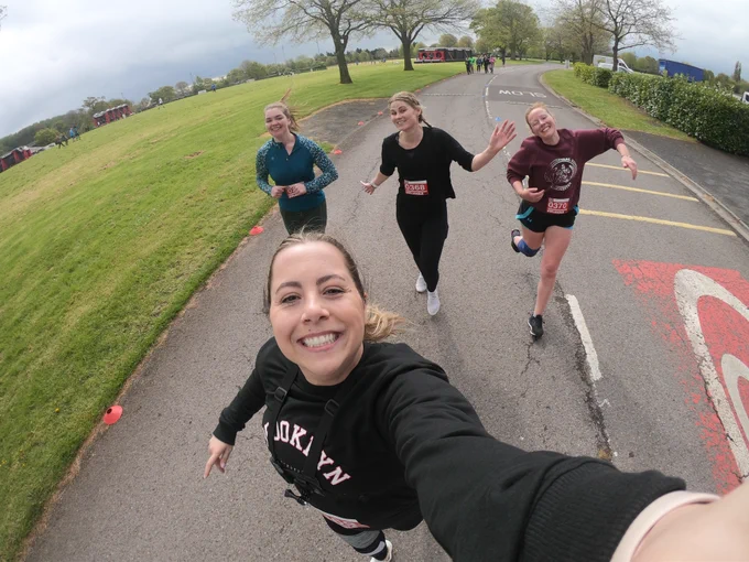 A group of four people taking part in the Exeter Inflatable 5K for for Open Up charity.