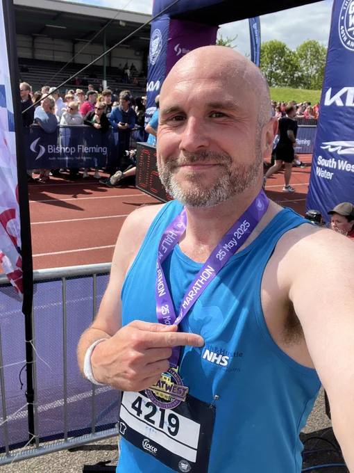 A runner taking part in the Great West Run 2025 for Open Up charity.