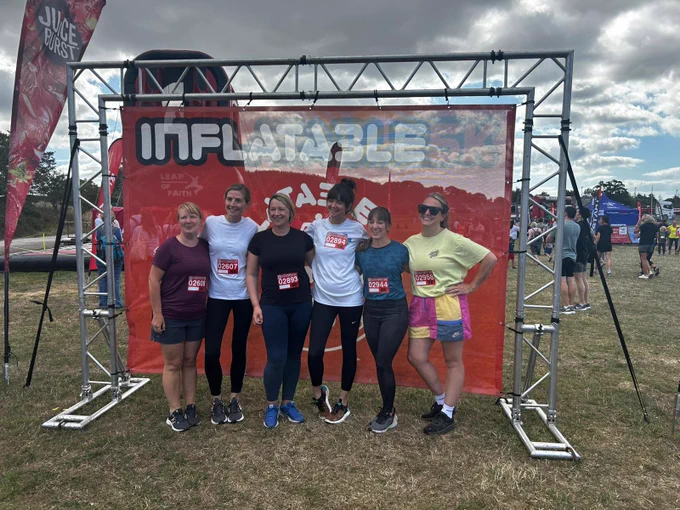 Members of the Children and Family Health Devon team taking part in the Exeter Inflatable 5K for for Open Up charity.